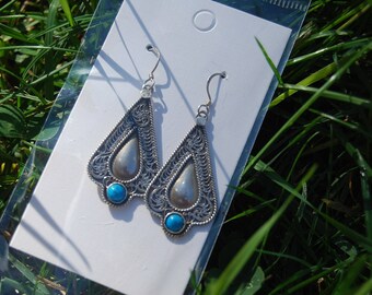 Tibetan tribal silver earring with turquoise.