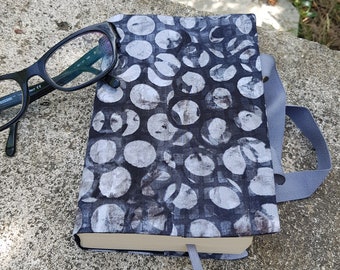 Fabric book cover for paperback with large gray peas on a black and gray background