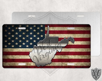 May include: A metal license plate featuring a distressed American flag design with a silver outline of the state of West Virginia and the text "West Virginia" in a silver script font.