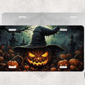 May include: A Halloween-themed license plate featuring a jack-o'-lantern with a witch's hat. The background is a dark forest with spooky trees and houses.