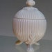 Beautiful white milkglass candy shaped ball streaked with veins supported by a tripod leaves pattern