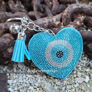 May include: A white ceramic mug with a black handle and the text "But First, Coffee" in a black, handwritten-style font. The mug is on a white surface.