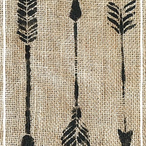 May include: Three black arrows are stenciled onto a burlap background. The arrows are different styles, with one having a feather design.