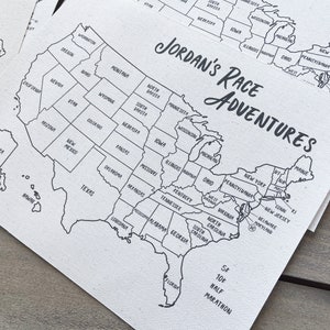 May include: A black and white map of the United States with the text "JORDAN'S RACE ADVENTURES" printed on it. The map shows the states and includes a note about a 5K and 10K half marathon.