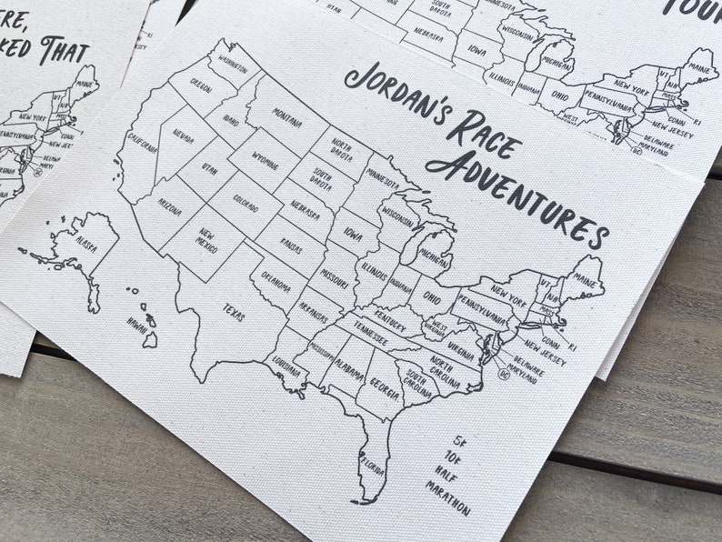 May include: A black and white map of the United States with the text "JORDAN'S RACE ADVENTURES" printed on it. The map shows the states and includes a note about a 5K and 10K half marathon.