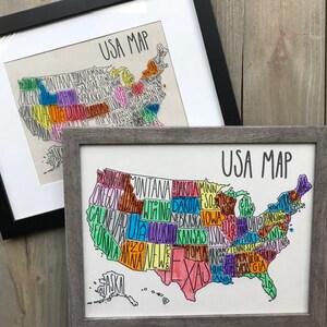 May include: Two framed prints of a hand-drawn map of the United States. The map is outlined in black and each state is filled in with a different color. The text "USA MAP" is written in black at the top of each print.