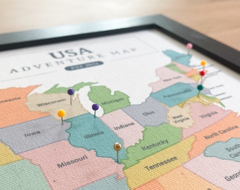 May include: A map of the United States with colorful states and push pins in various colors. The map is framed in black and has the text "USA ADVENTURE MAP EST 2011" at the top.