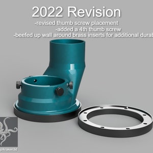 May include: A teal blue 3D printed telescope mount with a black base and a ring. The mount has four thumb screws and a text label that reads "2022 Revision -revised thumb screw placement -added a 4th thumb screw -beefed up wall around brass inserts for additional durability".