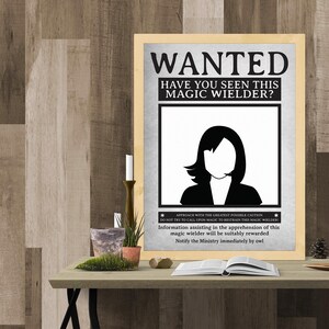 May include: A black and white wanted poster with the text "WANTED HAVE YOU SEEN THIS MAGIC WIELDER?" and a silhouette of a woman with long hair. The poster also includes the text "APPROACH WITH THE GREATEST POSSIBLE CAUTION DO NOT TRY TO CALL UPON MAGIC TO RESTRAIN THIS MAGIC WIELDER: Information assisting in the apprehension of this magic wielder will be suitably rewarded Notify the Ministry immediately by owl"