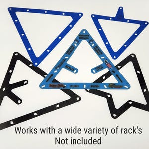 May include: A collection of five triangular billiard ball racks in blue and black. The central blue rack features text including Nielsen's Billiards, Solo, Load & Push, and Techno Duds. Below the racks, the text reads: Works with a wide variety of rack's Not included.