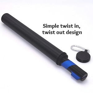 May include: A black cylindrical tube with a blue internal component, featuring a separate black circular cap with a silver carabiner. The text "Simple twist in, twist out design" is printed in black next to the tube on a white background.