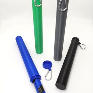 May include: Four cylindrical storage tubes in green, gray, blue, and black, each featuring a matching cap and a silver metal carabiner attached to the top. A small blue circular tag with a silver carabiner is positioned in the center.
