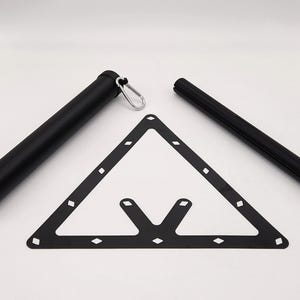 May include: A black pool table accessory set, including a triangle rack, a cue stick, and a cue stick holder. The triangle rack is black with diamond-shaped cutouts. The cue stick holder has a silver carabiner clip.