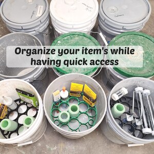 May include: A collection of gray and white buckets, some with green lids, filled with various items. The image includes the text "Organize your item's while having quick access". The buckets contain items like bottles, tubes, and other supplies.