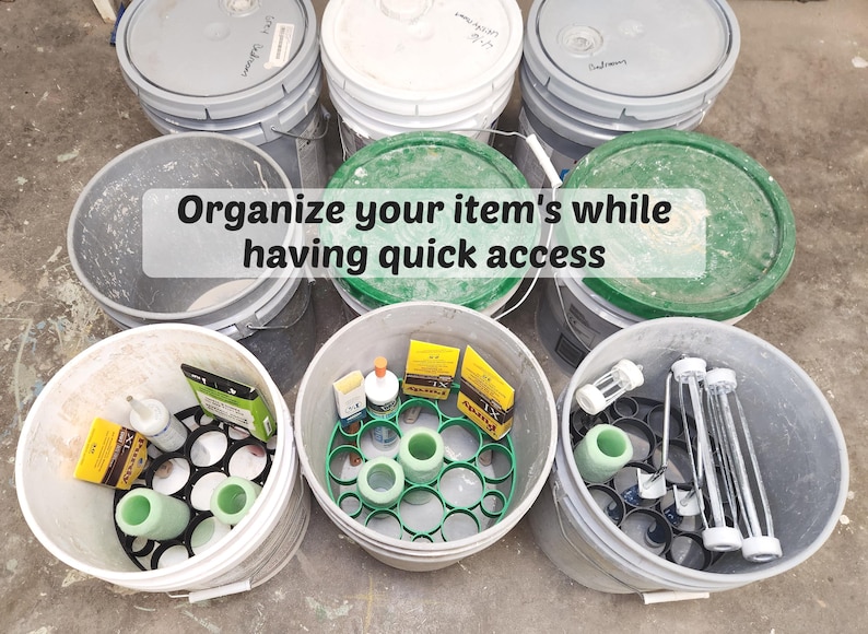 May include: A collection of gray and white buckets, some with green lids, filled with various items. The image includes the text "Organize your item's while having quick access". The buckets contain items like bottles, tubes, and other supplies.