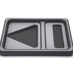 May include: A rectangular black and silver tray with three distinct sections. The tray has a raised edge and a silver interior. Two sections have a ridged, dark gray surface.