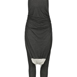 May include: A black sleeveless jumpsuit with a gathered waist and a white panel at the crotch.