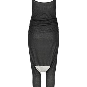 May include: Black sleeveless jumpsuit with a gathered waist and a unique leg design. The jumpsuit is made of a soft, stretchy fabric.
