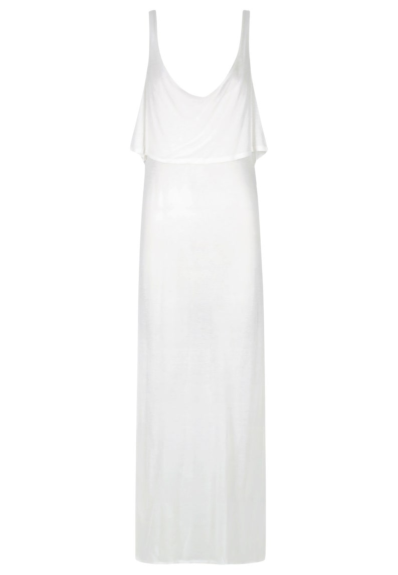 May include: A white sleeveless maxi dress with a ruffled neckline.