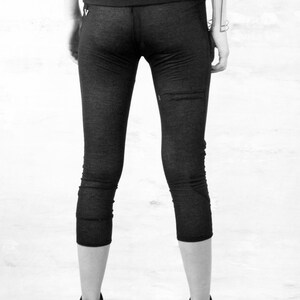 May include: Black cropped leggings with a wide waistband.