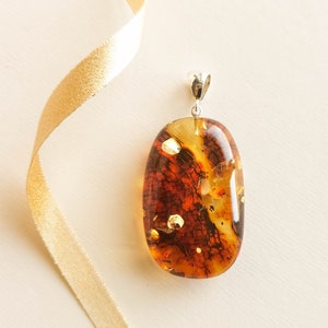 Dark cognac shiny amber pendant with silver 925, oval shape luxury red pendant from genuine amber for women, cognac amber pendant with skin