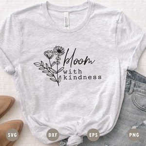 May include: A gray t-shirt with a floral design and the text "Bloom with kindness".