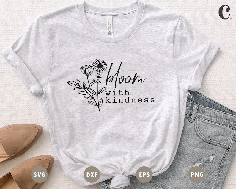 May include: A gray t-shirt with a floral design and the text "Bloom with kindness".