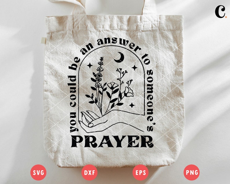 K&ouml;nnte beinhalten: Eine wei&szlig;e Einkaufstasche mit schwarzem Text, der "You could be an answer to someone's prayer." lautet. Der Text ist in einer stilisierten Schriftart gehalten und von einem schwarzen Halbmond und einem floralen Design umgeben.