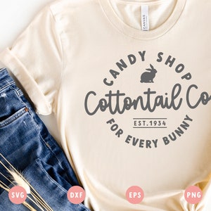 May include: A beige t-shirt with a gray circle design that says "Candy Shop Cottontail Co. Est. 1934 For Every Bunny". The design also includes a silhouette of a rabbit.