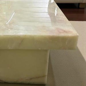 Luxury natural onyx stone table with unique crystal patterns used as a centerpiece in a contemporary living room