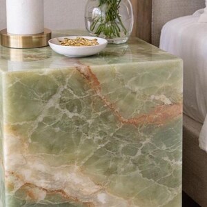 Elegant onyx plinth table styled with lamp and decor accessories