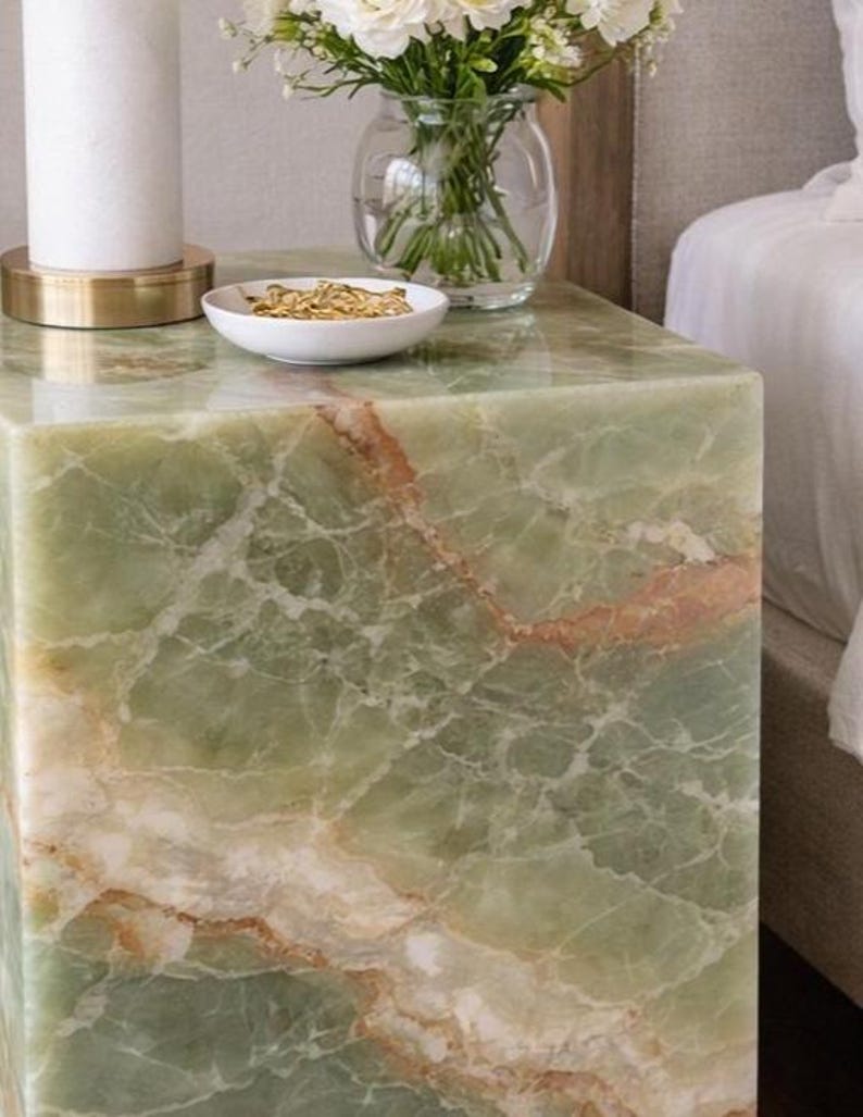 Elegant onyx plinth table styled with lamp and decor accessories