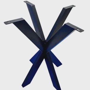 May include: A black metal table base featuring a central hub with four angled legs extending outward. Each leg terminates in a flat mounting plate with a pre-drilled slot for attachment. The structure is constructed from solid, dark-finished steel.