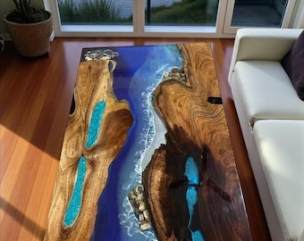 Mesa de comedor artesanal de resina epoxi con diseño de olas oceánicas y borde natural de nogal.