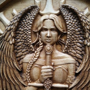 May include: A wooden carving of a winged figure holding a sword. The figure has long hair and is wearing a decorative belt. The carving is detailed and intricate.