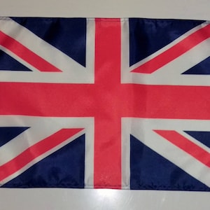 May include: A Union Jack flag, red, white and blue, made of a thin, woven fabric with a white border.