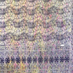 May include: A colorful batik fabric with a repeating pattern of waves and floral designs. The fabric is primarily black with white, yellow, pink, and blue accents.