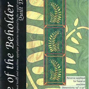 May include: Woodland Fern table runner pattern, featuring a green and gold fern design. The pattern is for reverse appliqué and can be done by hand or machine. The table runner measures 14 inches by 56 inches. "Take a walk in the woods in the cool of the day."  pattern & design by Margaret Brewster Willingham