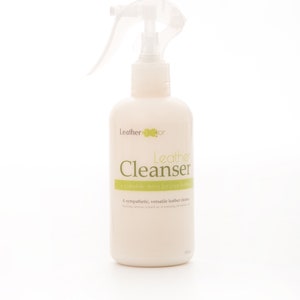 May include: A white plastic bottle with a green and white label that says "Leather Cleanser" and "A complete detox for your leather".