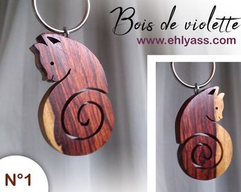Handmade wooden keychain featuring a cat in profile with a curled tail, by Ehlyass