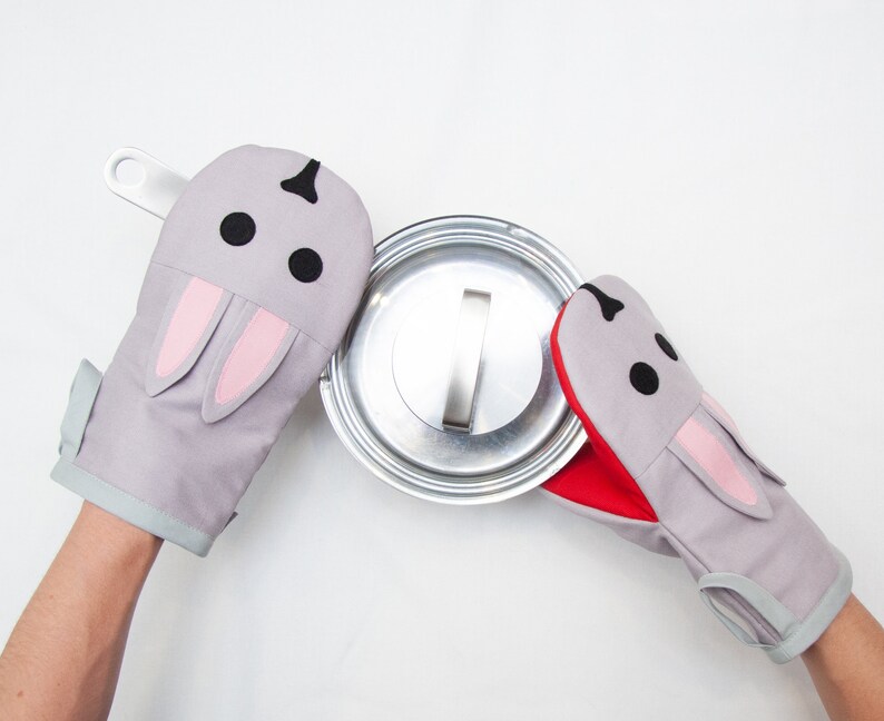 2 bunny oven mitts with a pot