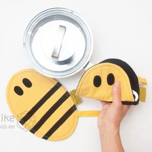 bumble bee pot holder being used to lift a pot