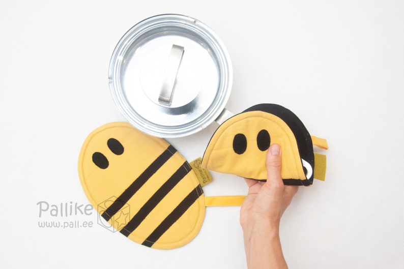 bumble bee pot holder being used to lift a pot