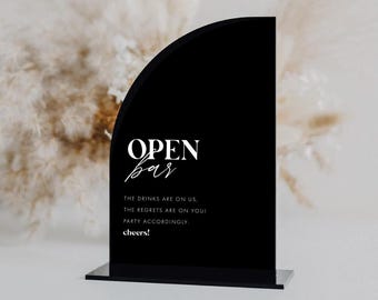 May include: Black acrylic sign with rounded edges that reads "OPEN bar" in white text. The sign also includes the text "THE DRINKS ARE ON US, THE REGRETS ARE ON YOU! PARTY ACCORDINGLY. cheers!"