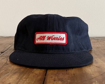 All Worries Patch Unconstructed 6 panel hat flat brim and adjustable strap backing (multiple colors)