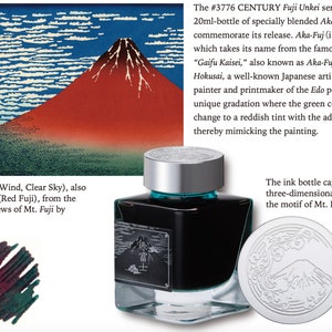 May include: A 20 ml bottle of green ink with a silver cap. The bottle features a label with a black and white image of Mount Fuji. The cap features a three-dimensional illustration of Mount Fuji with clouds. The ink is called "Aka-Fuji" and is inspired by the famous painting "Gaifu Kaisei" by Katsushika Hokusai.