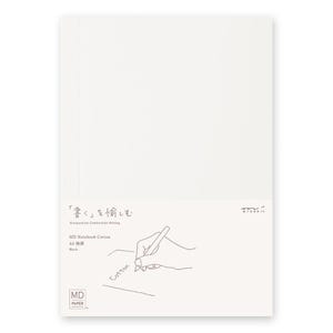May include: A white A5 MD Notebook Cotton with the text "Designed for Comfortable Writing" and Japanese text. The notebook features a line drawing of a hand writing with a pen. The word "Cotton" is also written on the notebook.