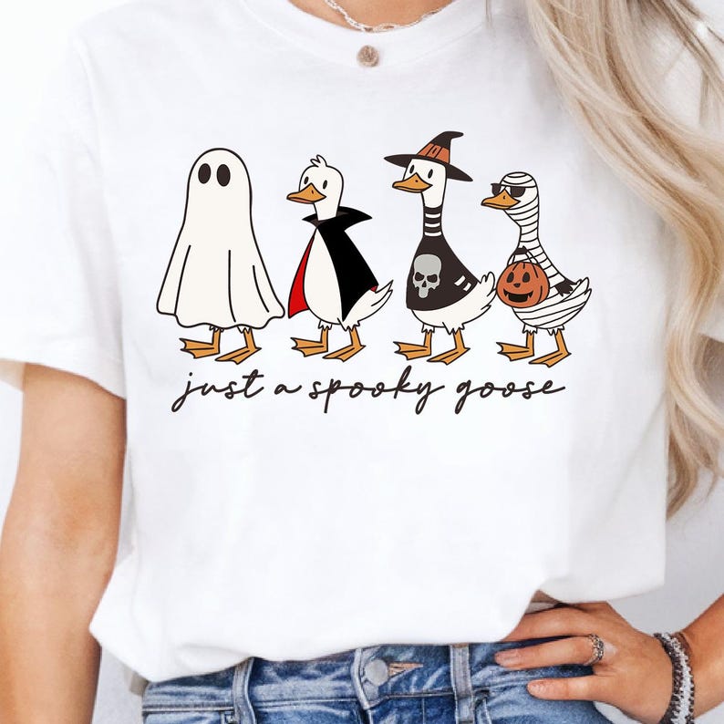 a woman wearing a white t - shirt that says just a spooky goose