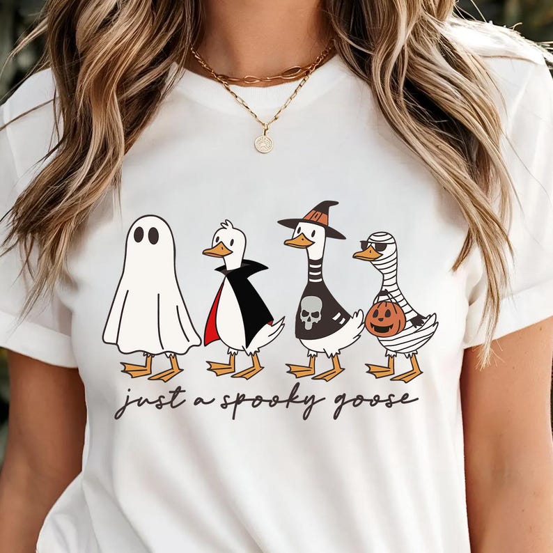 a woman wearing a white t - shirt with three cartoon characters on it
