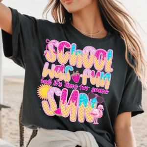 May include: Black t-shirt with a pink, blue, and yellow graphic that says "School was fun but it's time for some sun". The graphic is designed to look like an ice cream cone with sprinkles and a strawberry.